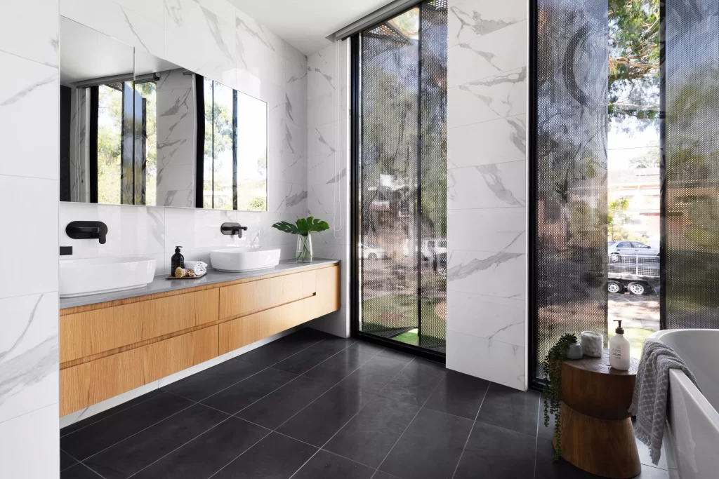 bathroom with large windows and cropped freestanding tub with large rectangular mirrors and double sink